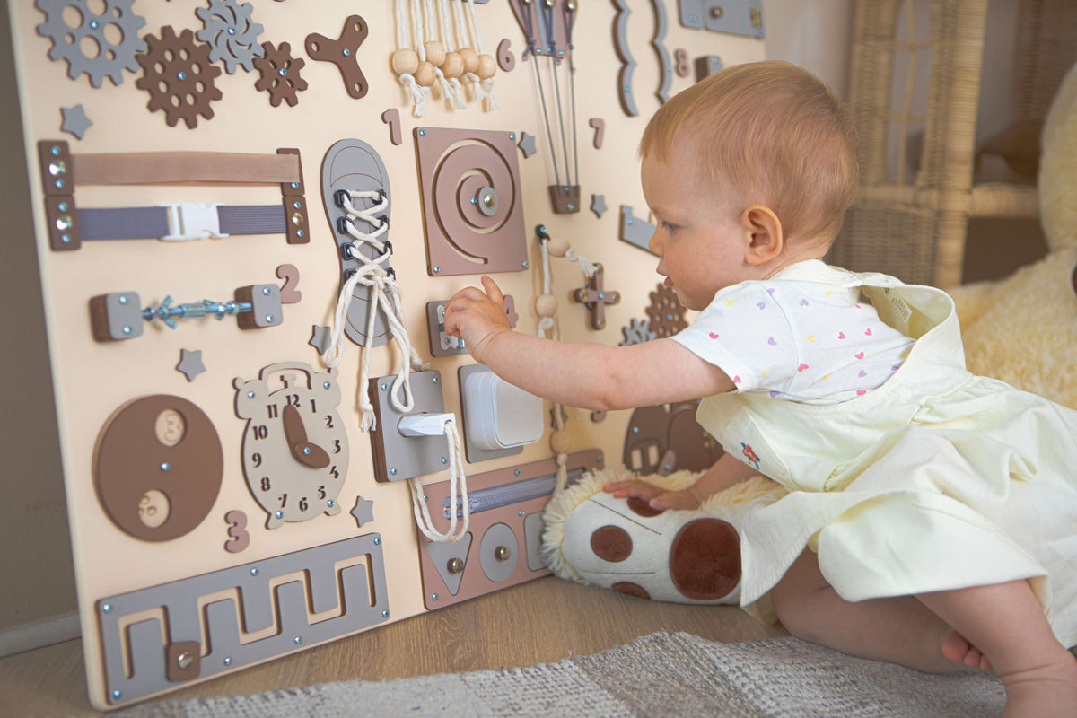 The child plays with a busy board